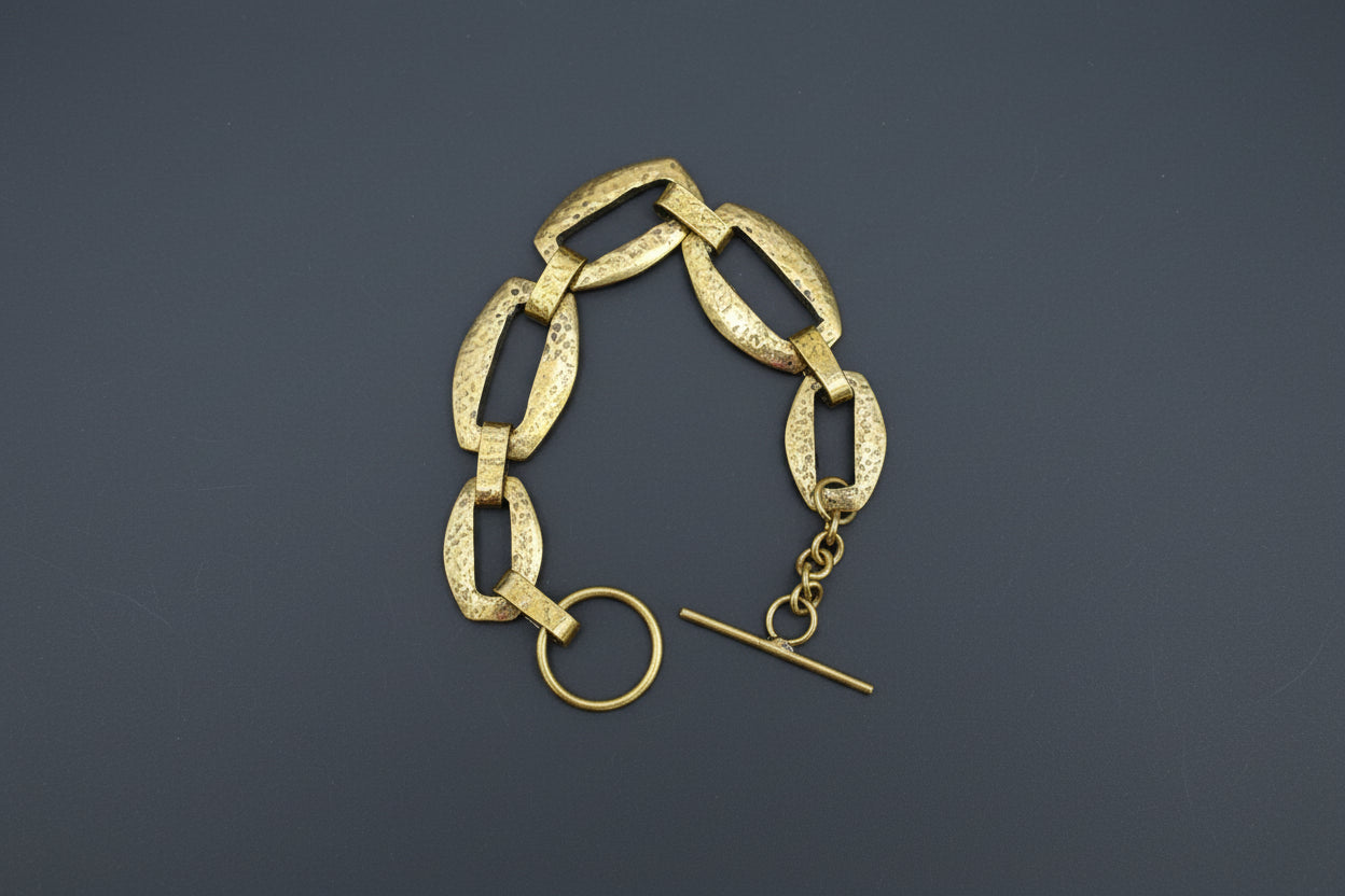 Gold chain bracelet with clasp on a dark background