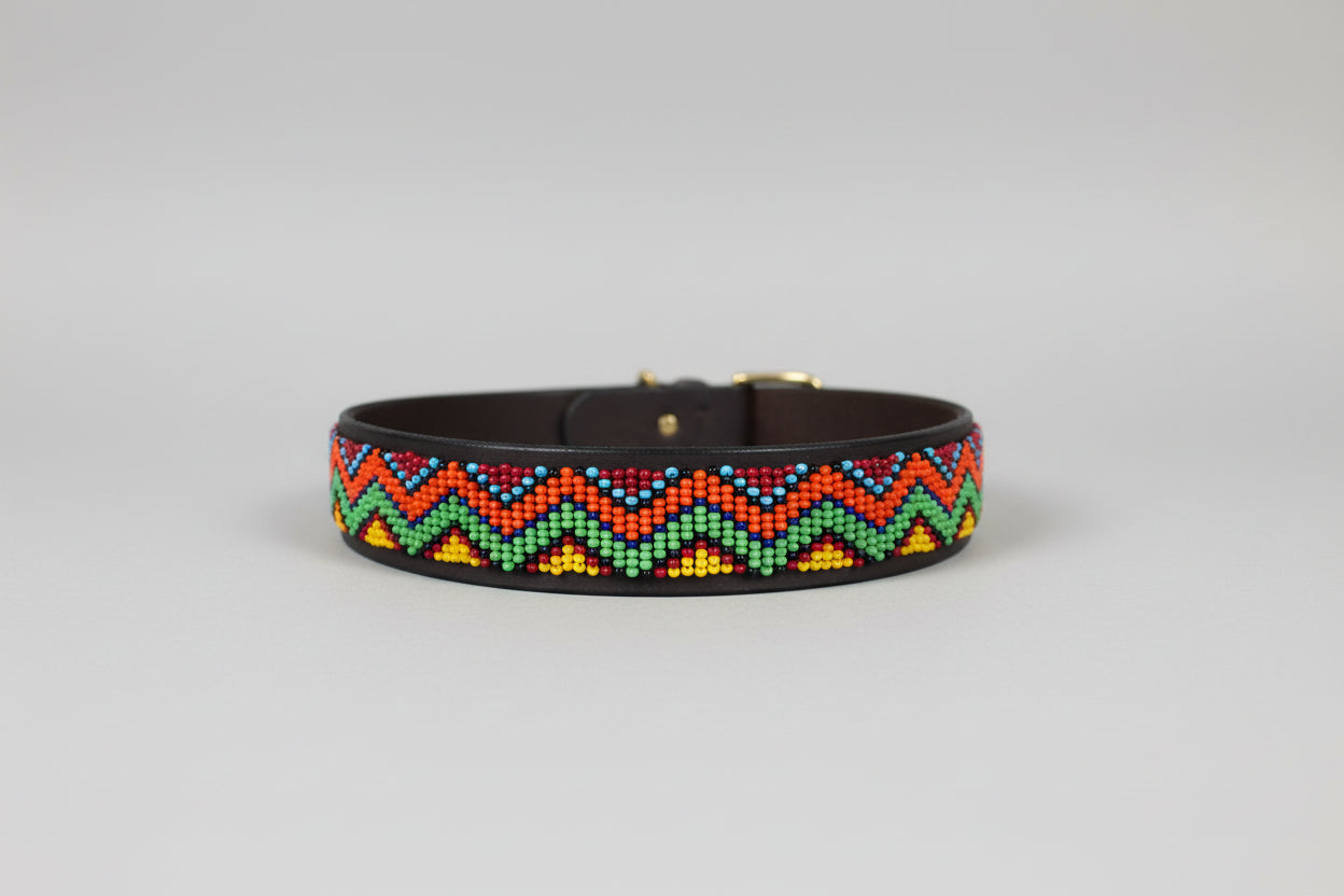 Beaded dog collar with colorful zigzag pattern on a grey background