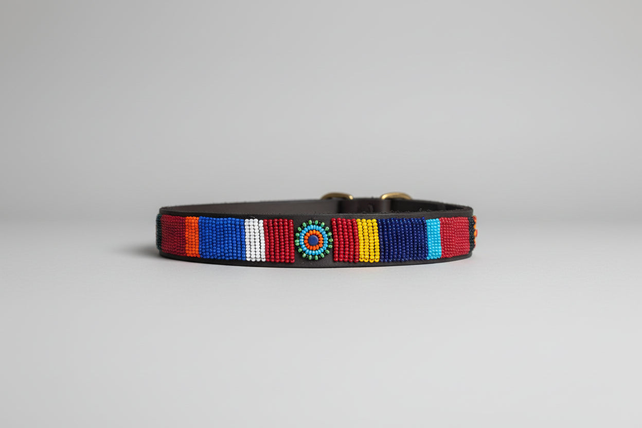Colorful beaded dog collar on a beige surface with a blurred indoor background