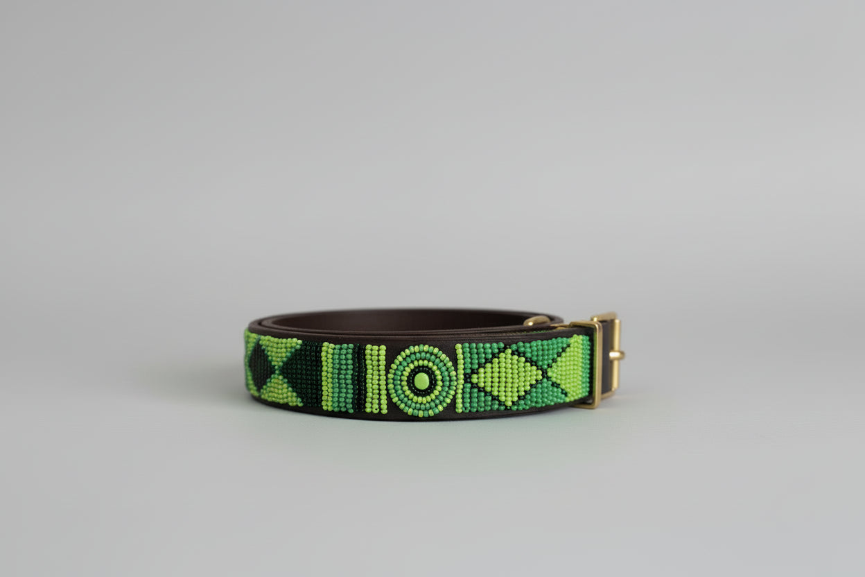 Green and dark green beaded collar on a grey background