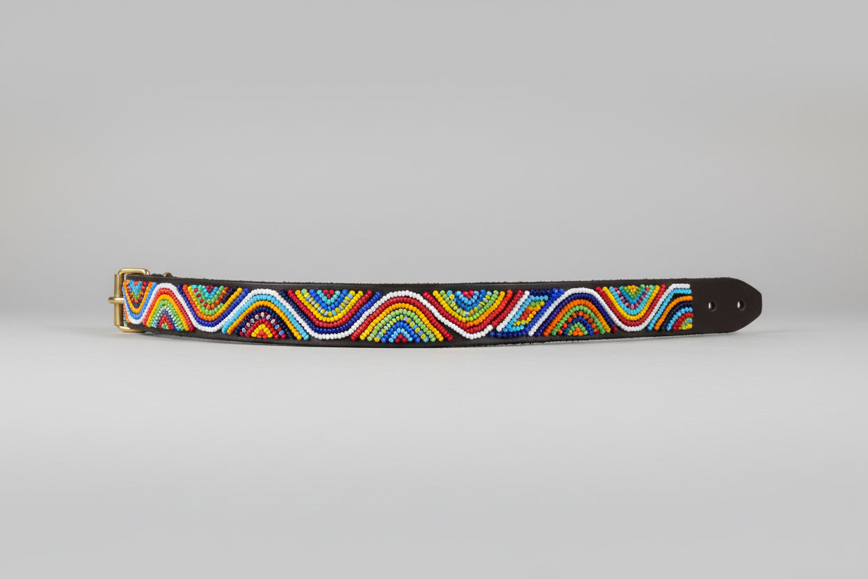 Colorful beaded bracelet on a beige surface with a blurred indoor background