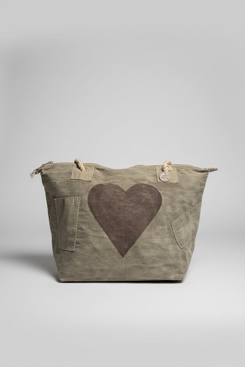 Grey tote bag with a heart design on a gray background