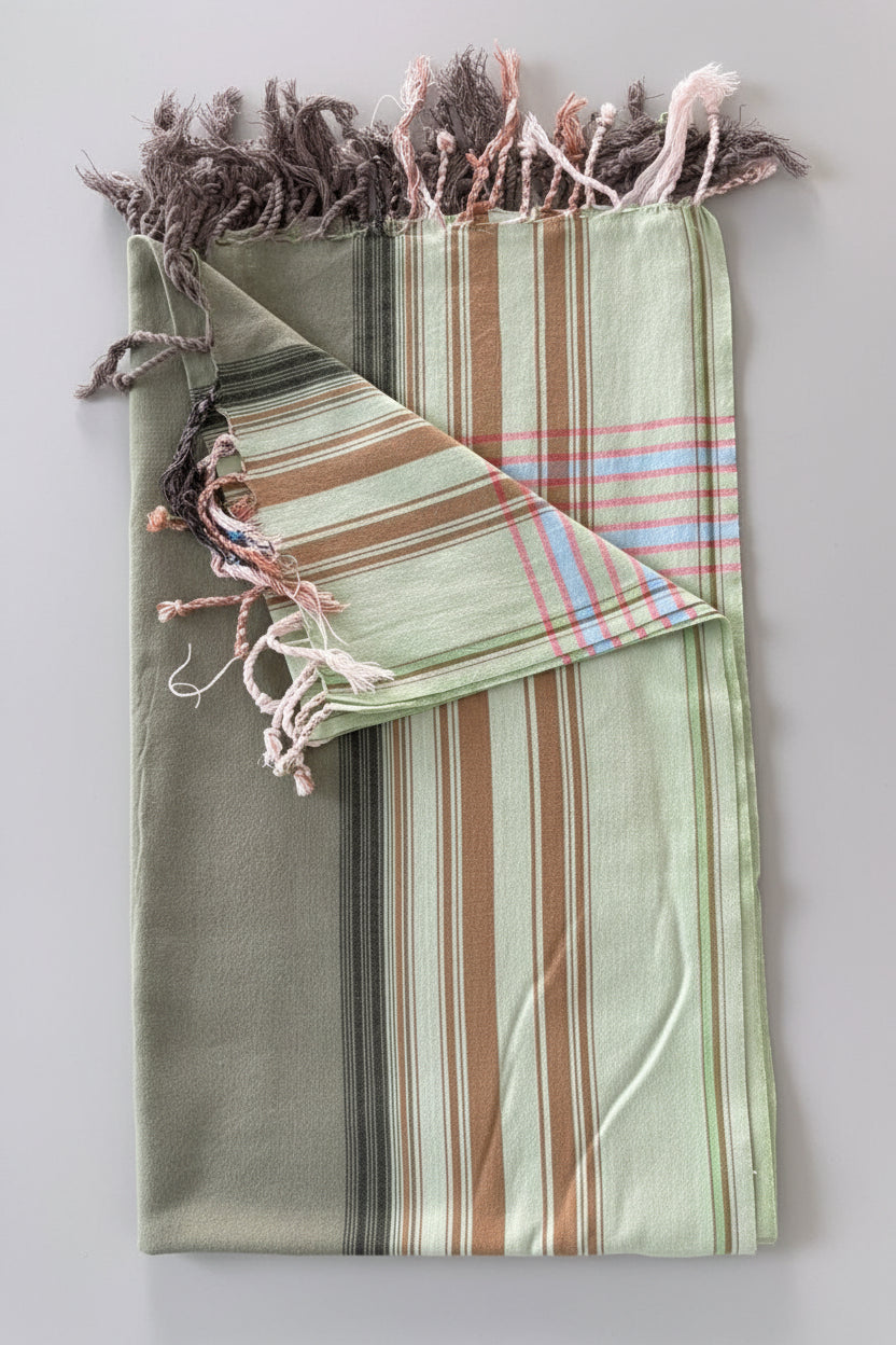 Folded fabric with striped pattern on a grey background