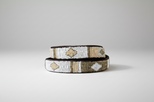 Two beaded bracelets with shell designs on a white background