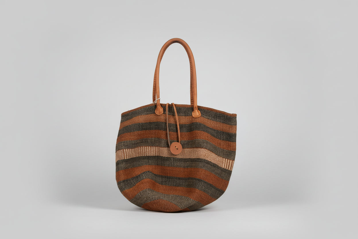 Striped handbag with brown and grey pattern on a light grey background