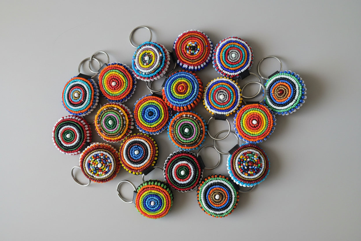 Colorful circular keychains arranged on a light gray background