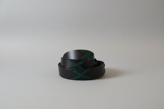 Black belt with green pattern on a light gray background