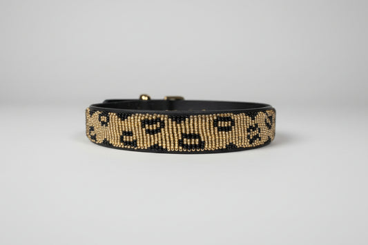 Beaded collar on a beige surface with a blurred indoor background