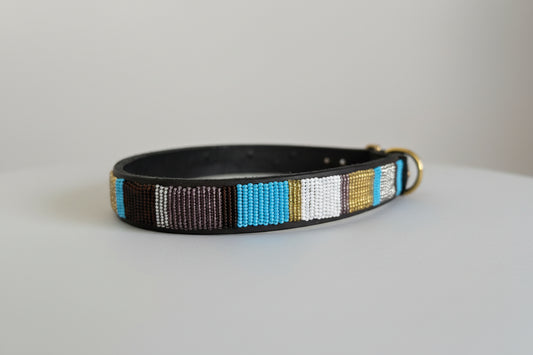 Dog collar with colorful beaded design on a light grey background