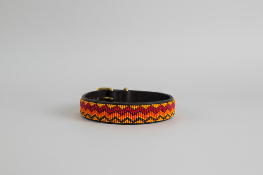 Beaded dog collar with a colorful pattern on a grey background