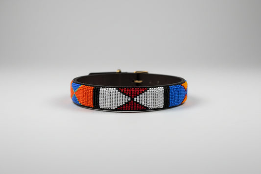 Colorful beaded bracelet on a brown surface with a blurred indoor background