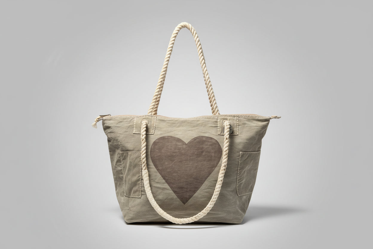 Grey tote bag with a heart design on a gray background
