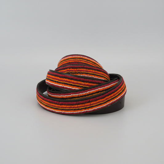 Colorful belt with black strap on a gray background