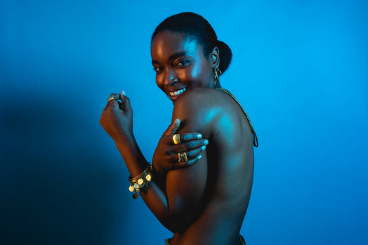 Woman with jewelry against a blue background