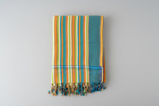Striped towel with colourful pattern on a grey background
