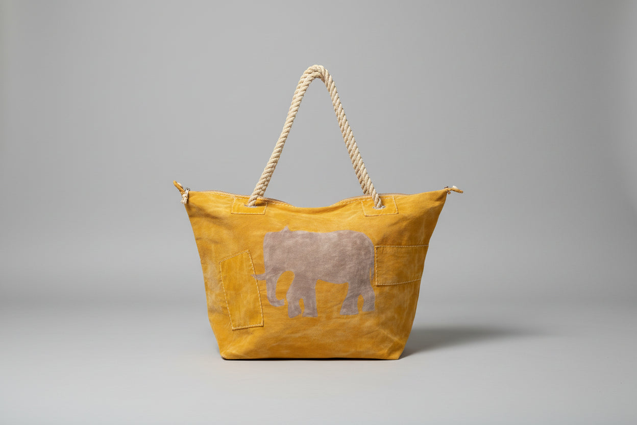 Yellow bag with a elephant design on a wooden surface